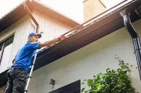 Roofer performing a roof inspection on a residential home.