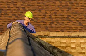 Roofer performing a roof leak inspection.