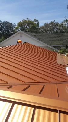 Metal Roof installed in Clearwater, FL by Done Rite Roofing. Done Rite Roofing Contractor can be seen at the far end of the roof.